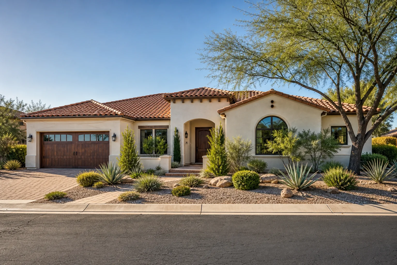 Completed Arizona residential tile roof with desert landscaping and strong curb appeal in afternoon sun