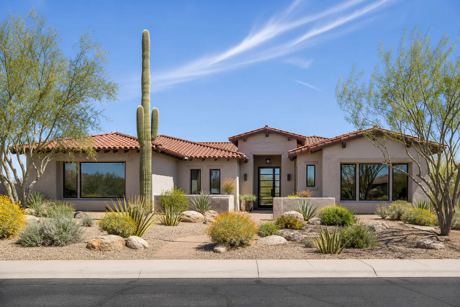 Energy-efficient windows installed on a modern Arizona stucco home with desert landscaping and tile roof