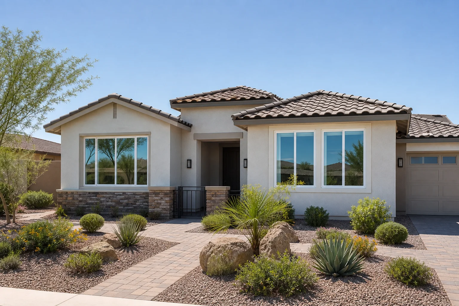 Newly installed replacement windows on a finished Arizona home exterior with desert landscaping
