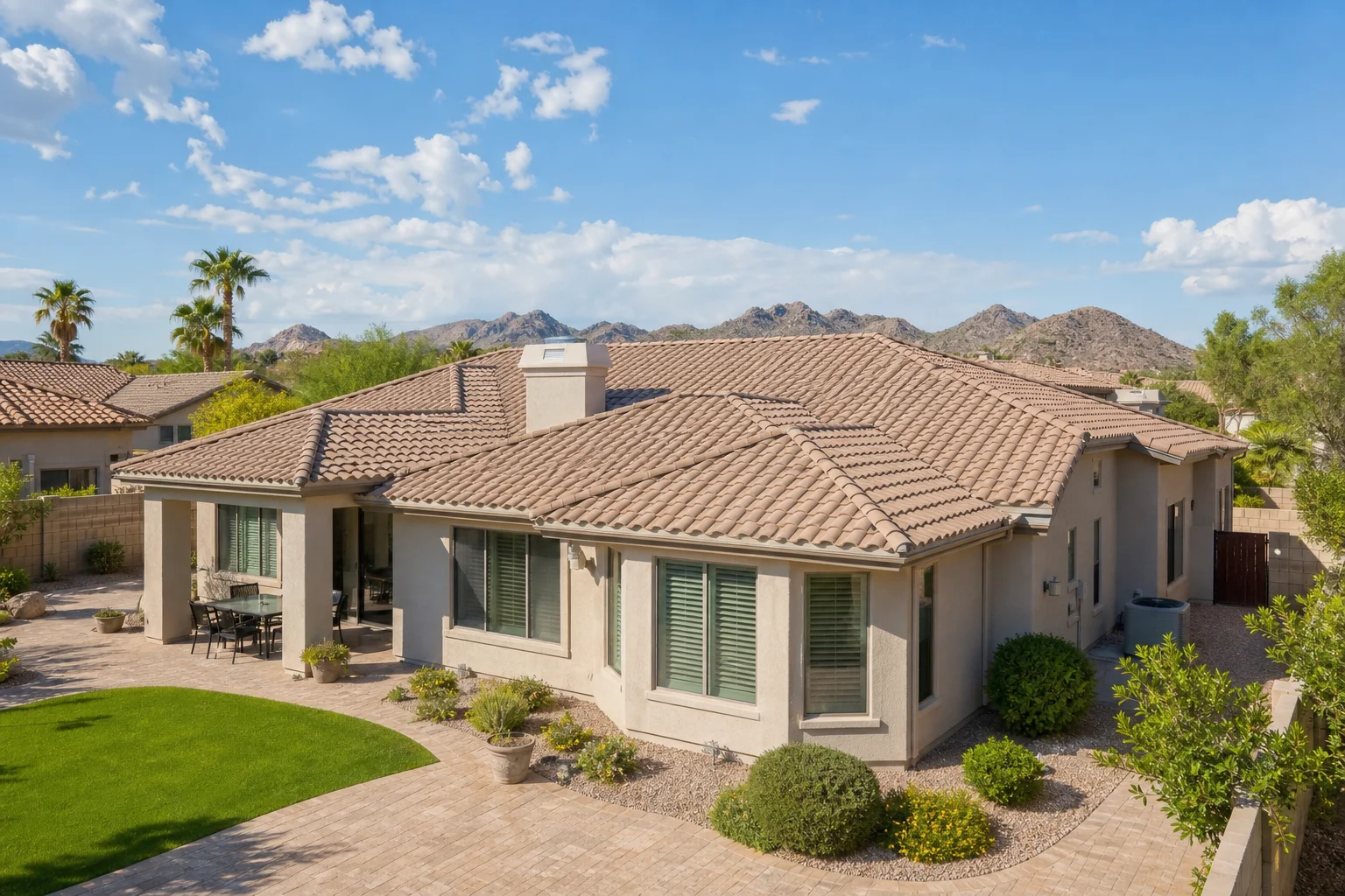 Wide exterior view of an Arizona home with a well-maintained tile roof and desert landscaping